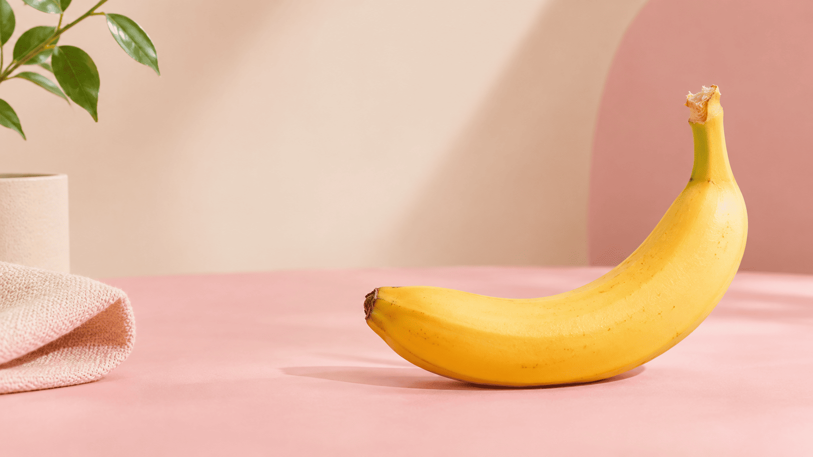 Banana sobre fundo rosa, imagem conceitual do artigo sobre saúde sexual masculina.